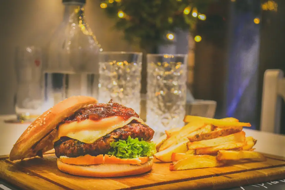 A burger and fries on a wooden board