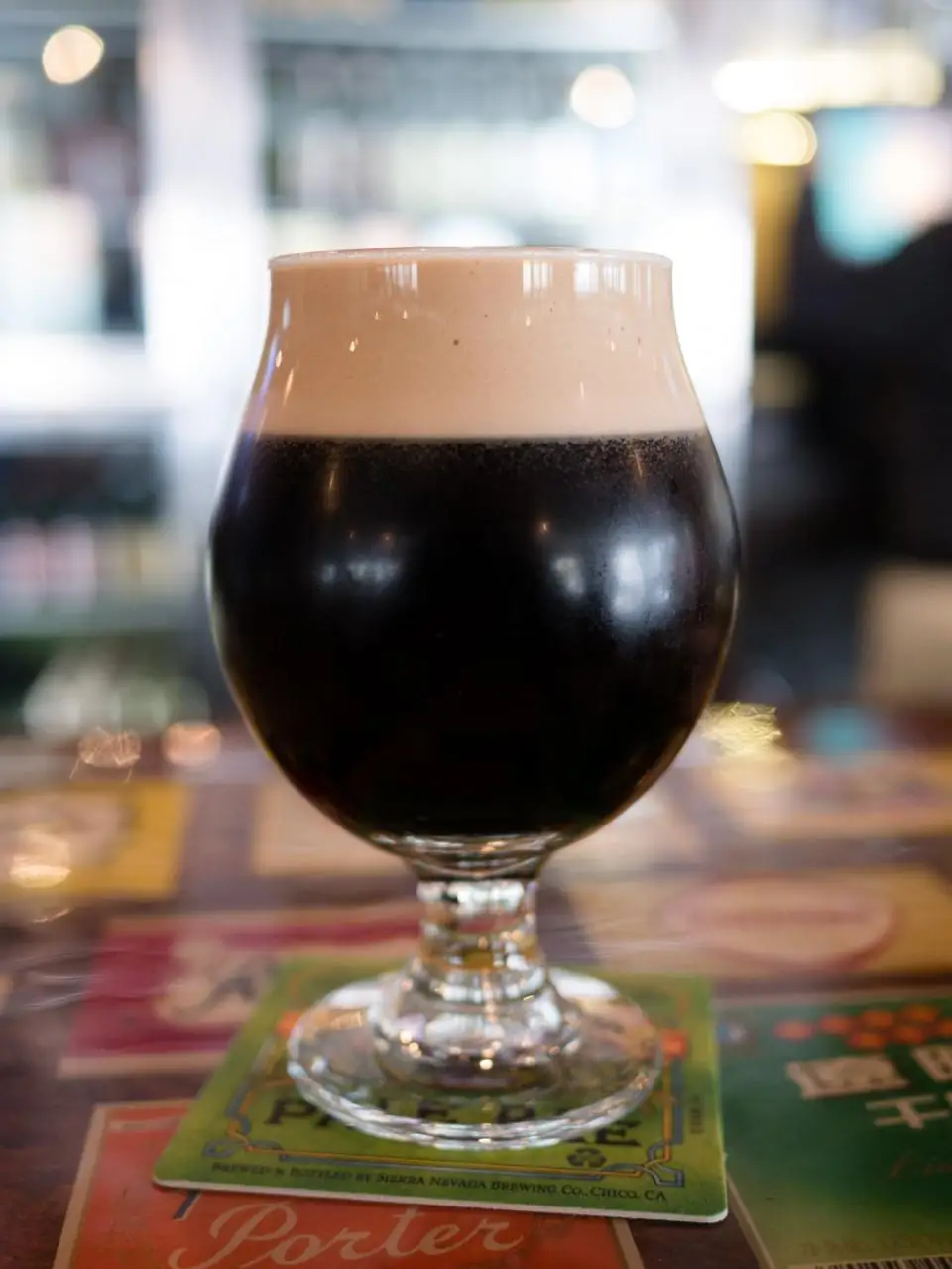A dark stout in a tulip glass with a tan head