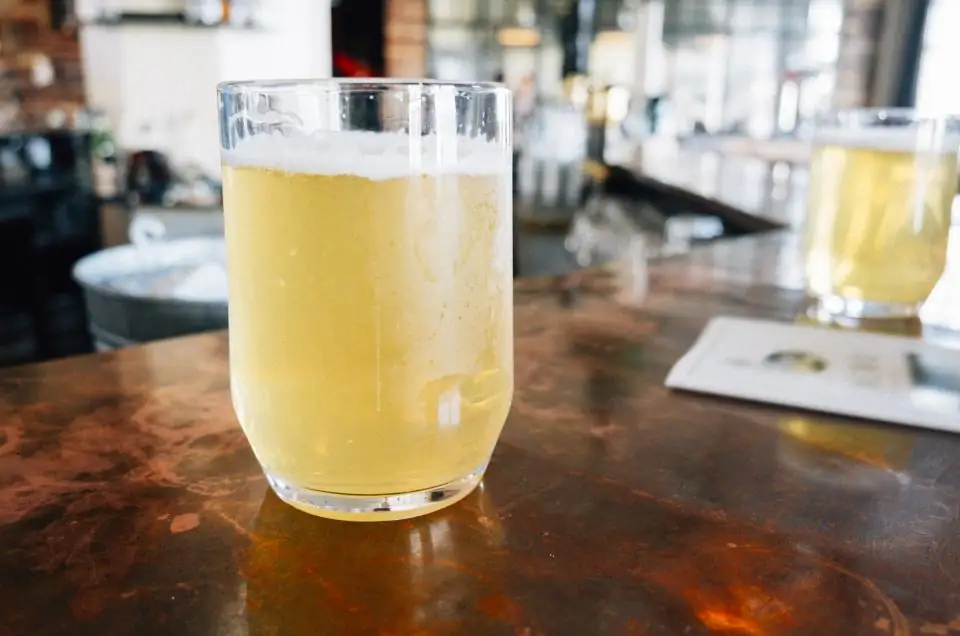 A hazy pale beer on a copper bar top